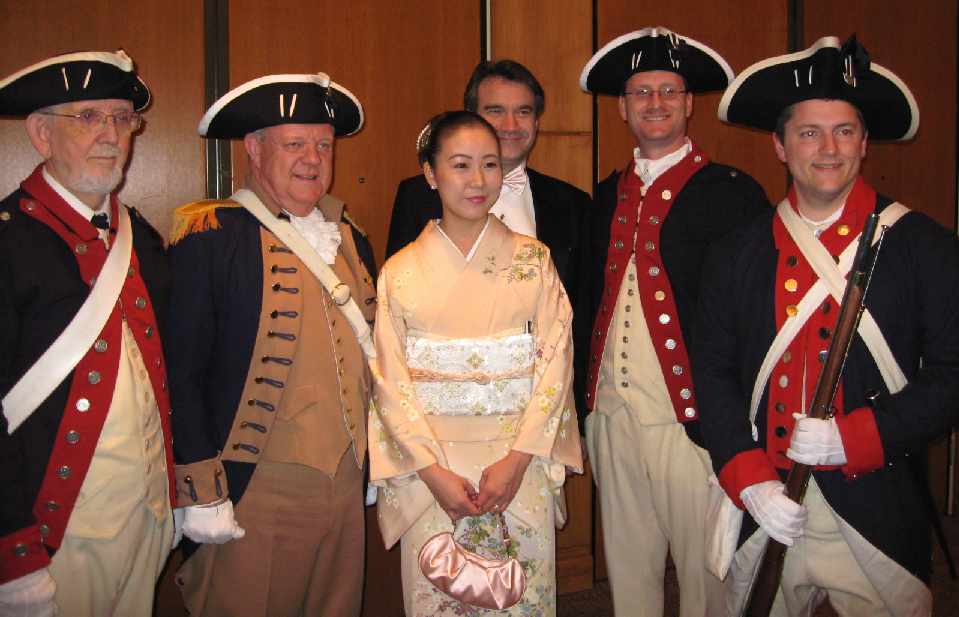 Members of the Color Guard Andy Johnson (right), Larry McKinley, Darrin Schmidt, and Dan Rolph grant a request to pose with some of the ball's attendees.