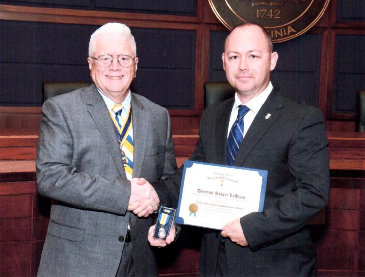 President Vernon Eubanks presents the Law Enforcement Commendation Medal to Detective LeBlanc.