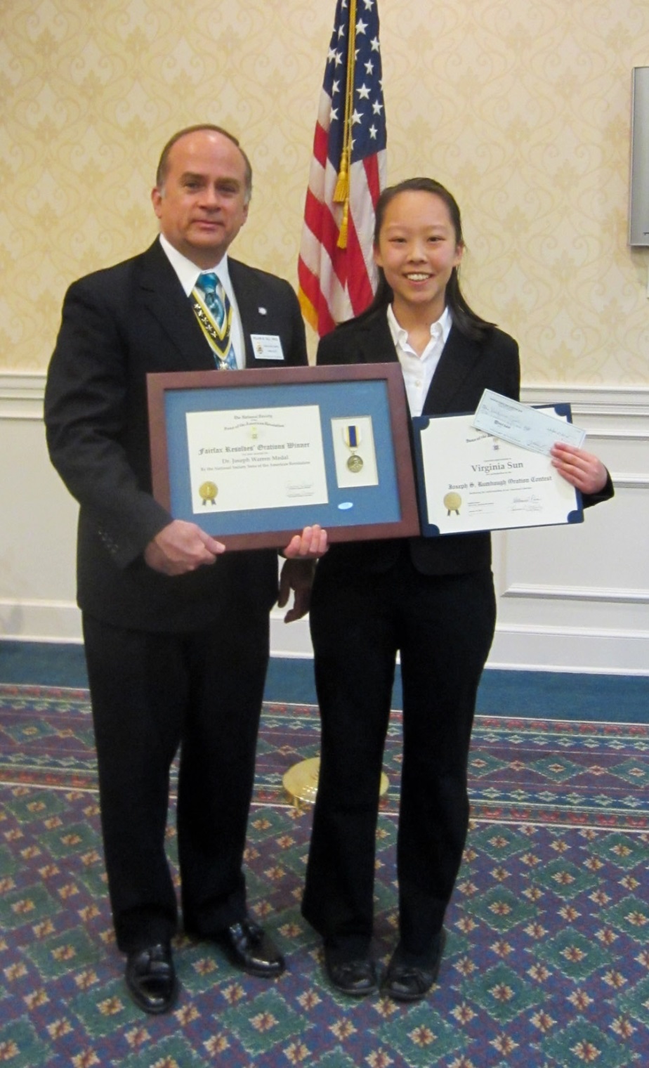 President Bill Price presents Virginia with a medal and certificate as the 2015 oration winner. The chapter continues to support the national oration endowment fund and made a contribution in Virginia's name. President Price also presents a framed endowment fund, Joseph Warren medal in honor of Virginia's oration.